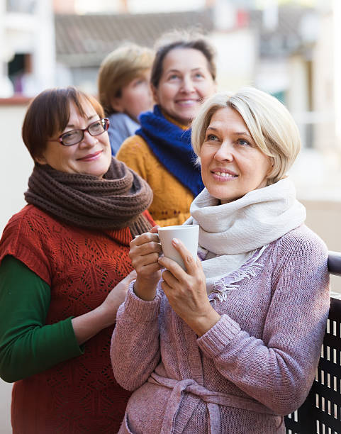 istock Senior women drinking tea at balcony 488310016