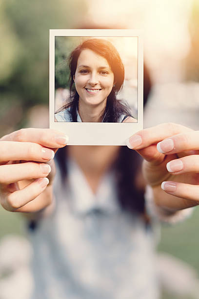 istock Girl holding instant selfie 488310646