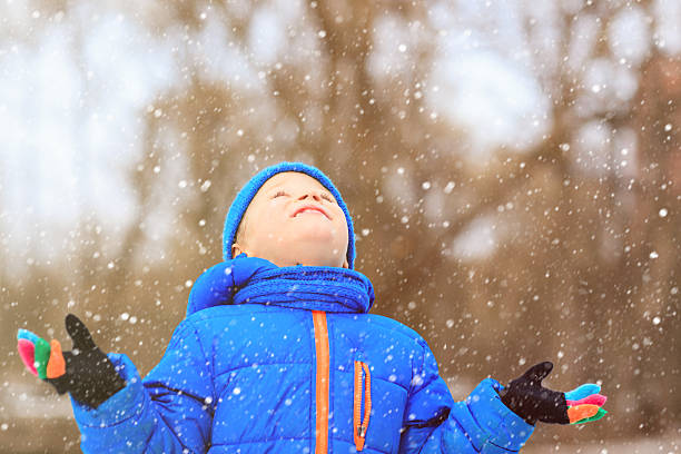 istock little boy enjoy first snow in winter nature 488310884