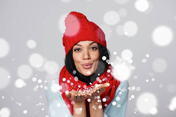 istock Winter girl blowing snow at you 488312458