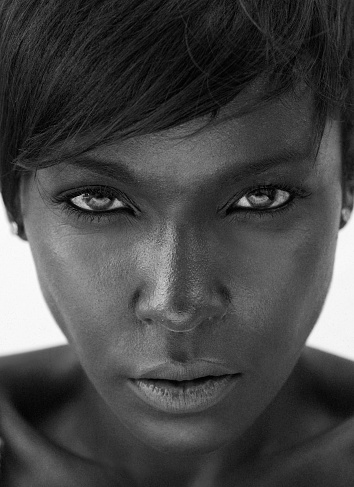Close up black and white portrait of a beautiful african american woman staring