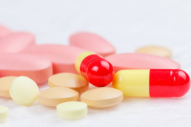 istock Multicolored Tablets of medicine on white background. 488313912