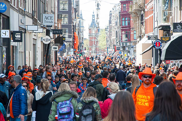 Crowd of people on Amsterdam street during King's Day. stock photo