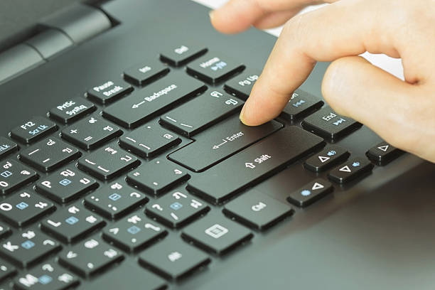 istock Close-up of typing female hands on keyboard enter 488315038