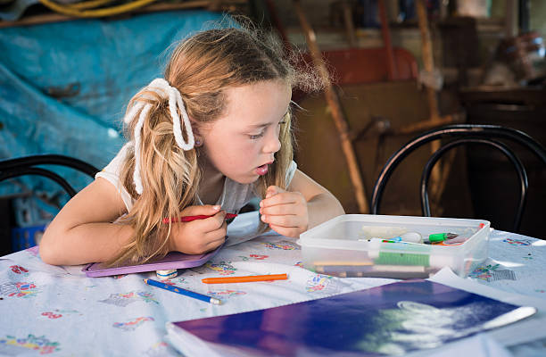 istock Little blonde girl drawing with crayons 488315722