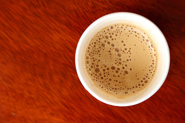 istock Hot coffee in paper cup seen from top. 488316882