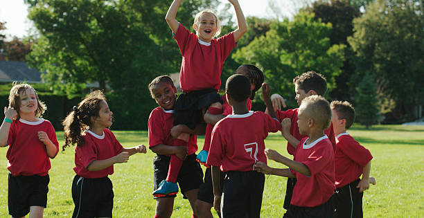 istock Teammates Cheering on Little Girl 488317376