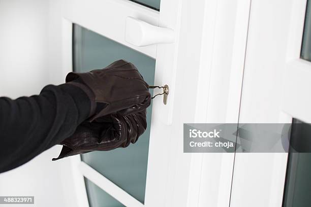 Burglar Using Special Tools To Break In A House Stock Photo - Download Image Now - Aggression, Burglar, Burglar Alarm