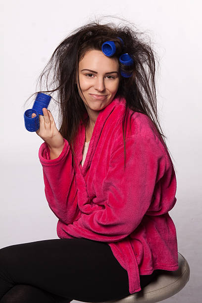 Young woman with curlers stock photo