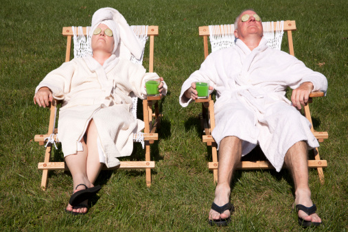 Mature couple detoxing during a do it yourself spa day in their backyard