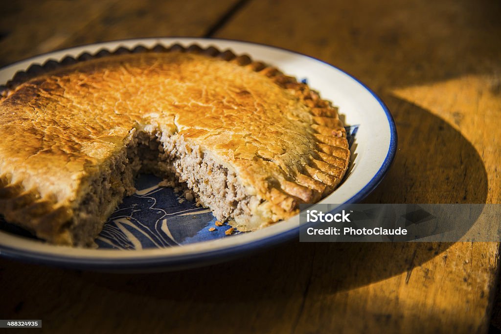 Meat pie Meat pie on a table with a slice missing using natural light Baked Stock Photo