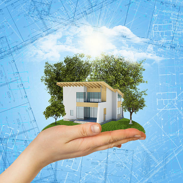 istock Hands holding a small house with land 488326199