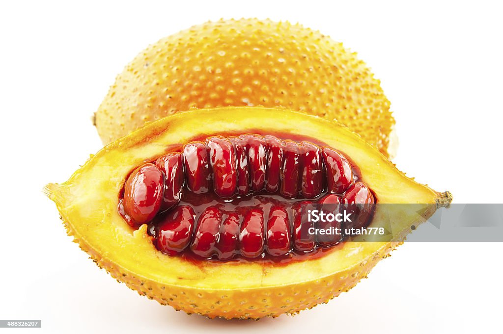 Gac Southeast Asian fruit, commonly know as Gac children Jackruit, spiny bitter gourd, sweet gourd Cochinchin Grourd or more features delicious and drugs isolated on a white background. Asia Stock Photo