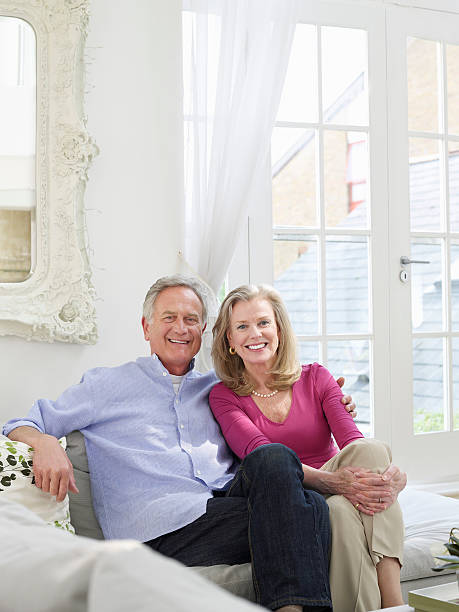 istock Smiling Mature Couple In White Home Interior 488328405