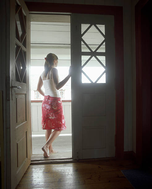istock Woman Standing In Open Door 488328407