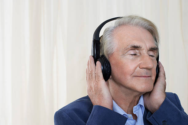 istock Senior Businessman Wearing Headphones 488328459