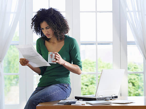 istock Displeased Woman reading document at home 488328495