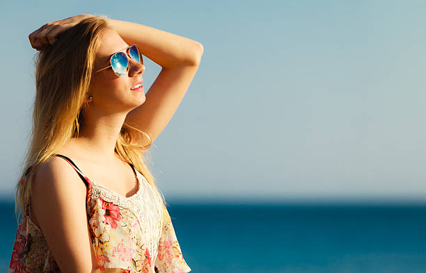 istock Summer vacation. Girl standing alone on the beach. 488330213