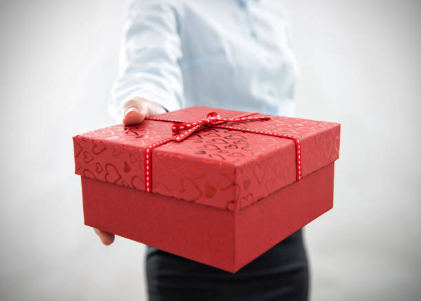 istock Businesswoman holding gift box 488330425