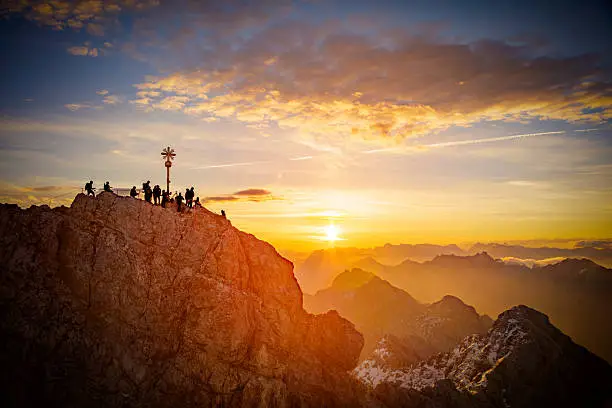 The summit of Mount Zugspitze, Germany's highest mountain in front of the rising sun.
