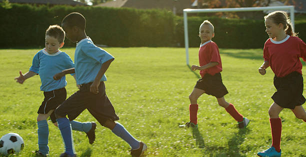 istock Boys Chasing After Soccer Ball 488350848