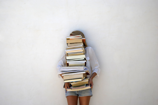 High School Student Holding Lots of Books