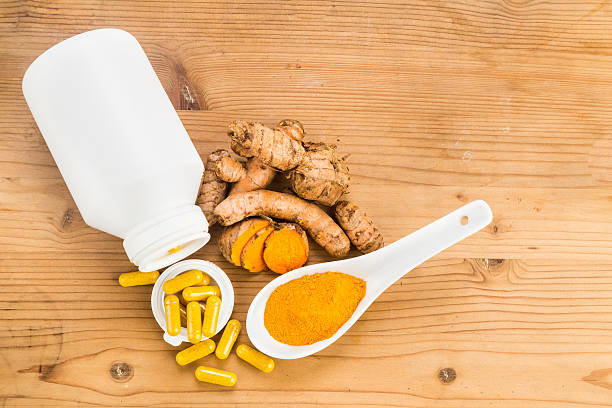 istock Homemade turmeric capsule from freshly grounded turmeric roots. 488355950