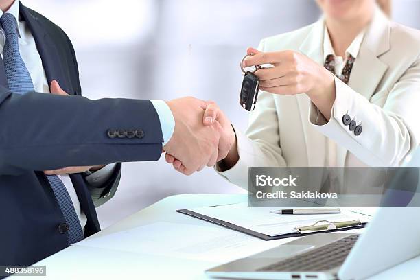 Car Salesman Handing Over The Keys For A New Car Stock Photo - Download Image Now - Contract, High Angle View, Holding