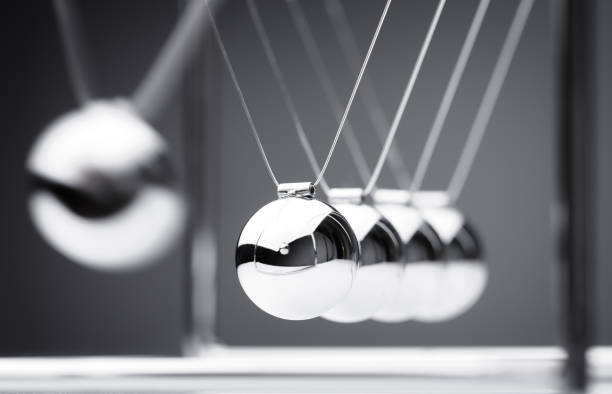 Newton's cradle Newton's cradle physics concept for action and reaction or cause and effect pendulum stock pictures, royalty-free photos & images
