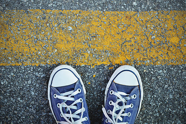 istock Blue Sneaker shoes standing behind the yellow line 488360698