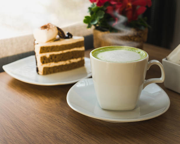 istock Close up hot Greentea matcha latte wood background 488360976