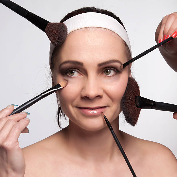 Applying makeup to the face stock photo