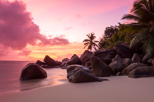Beautiful sunset in the tropical beach Petite Anse Kerlan in Praslin Island, Seychelles.
