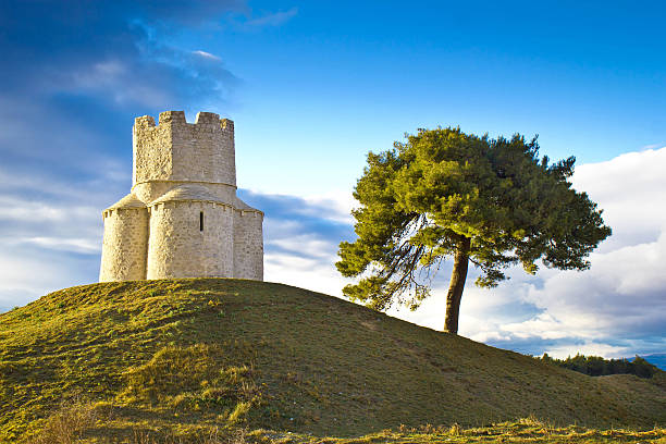 istock Idyllic green hill with stone church 488364265