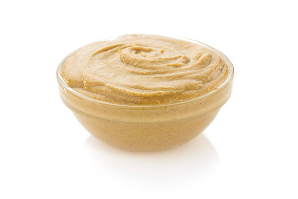 istock mustard sauce in bowl on white 488364425