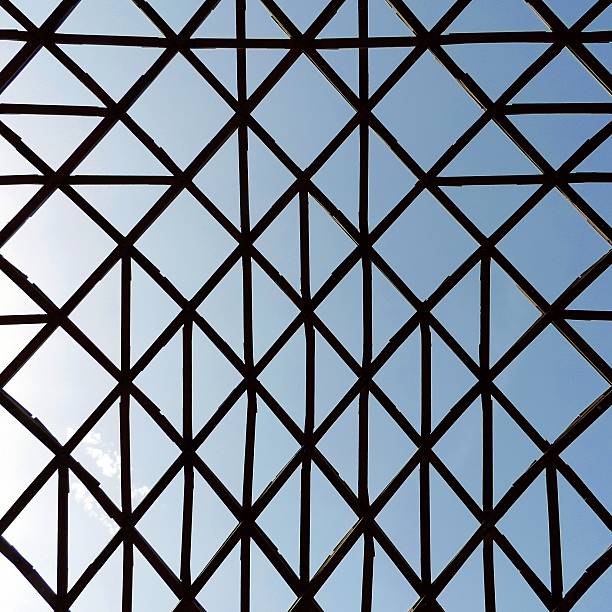 istock Geometric unusual structure with crossed wooden bars 488364598