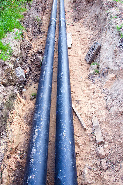 istock Two black waterpipes in a ditch 488364794