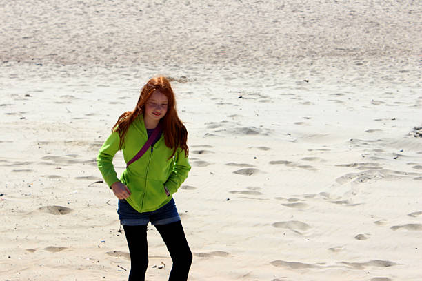 istock Image of girl on a scorching hot, sandy desert beach 488365643