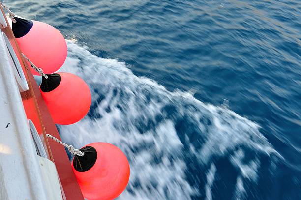 istock Red buoy on body of moving ship 488367985