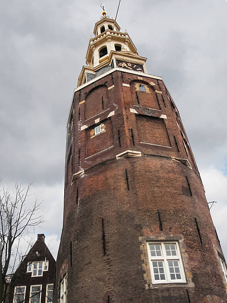 montelbaans башня против пасмурная небо. амстердам - montelbaan tower стоковые фото и изображения