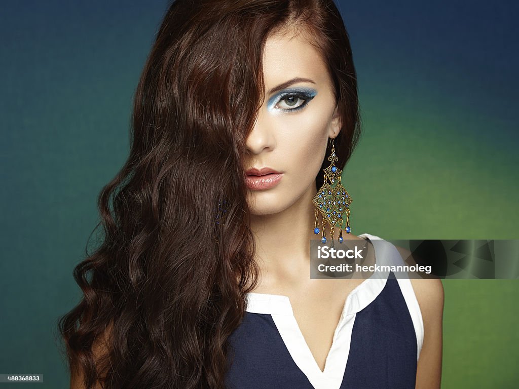 Portrait of beautiful brunette woman with earring. Perfect makeu Portrait of beautiful brunette woman with earring. Perfect makeup. Fashion photo Adult Stock Photo