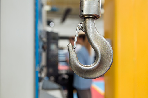 Close up shot of a metal hook in a factory.