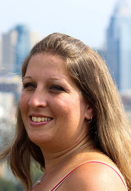 istock Smiling Woman Poses For Camera With Cincinnati Skyline in Background 488383566