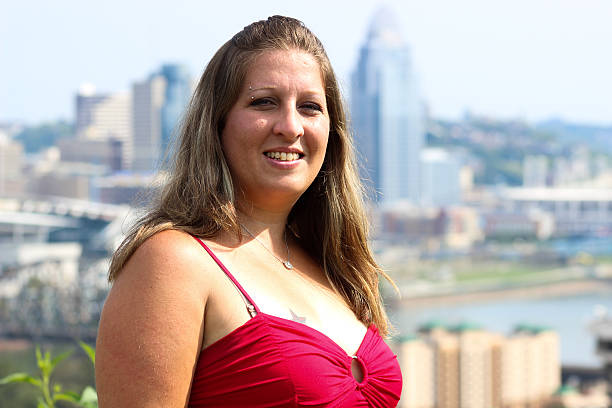 istock Smiling Woman Poses For Camera Against Cincinnati Cityscape 488383684