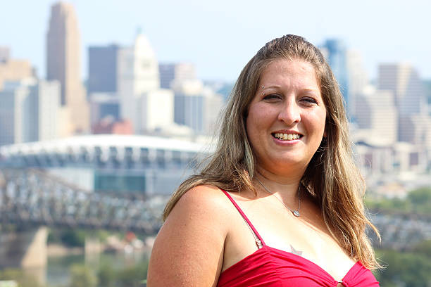 istock Woman Smiles While Posing For Camera With Cincinnati in Background 488383720