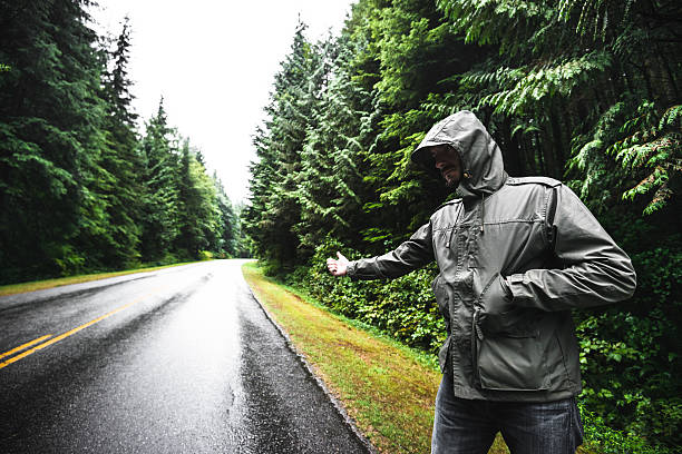 istock man doing the hitch-hiking on the forest 488384290