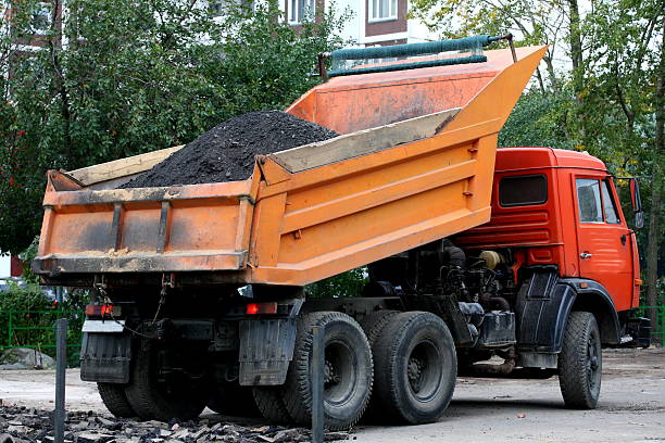 istock Truck dump pours asphalt 488384696