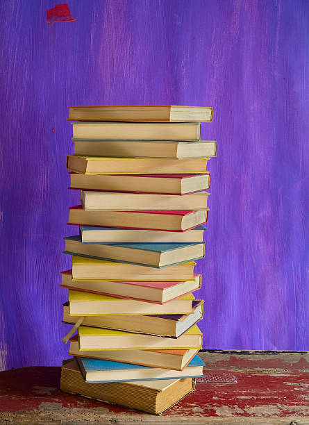 istock stack of books on purple,grungy background,free copy space 488384986