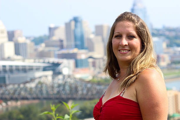 istock Woman Smiles For Camera With Cincinnati Skyline in Background 488385382