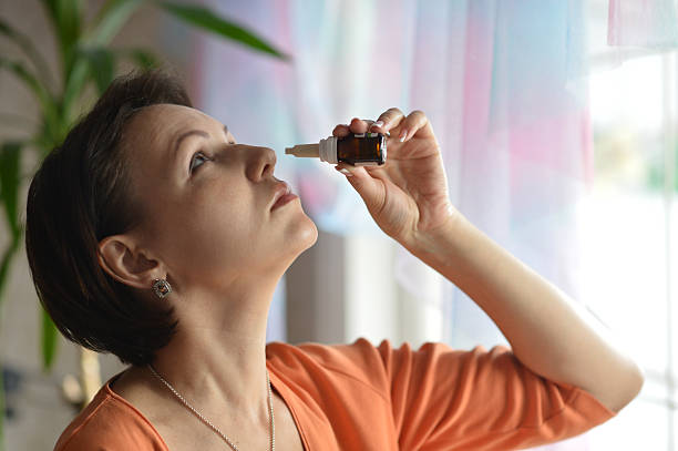 istock Woman with nasal drops 488386778